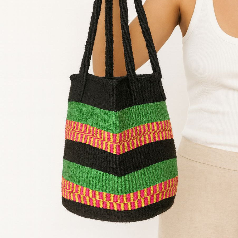 Colorful striped bag with black handles.